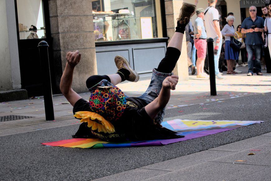 Un militant se débat et danse sur un drapeau LGBTQIA+, Pride 2023 à Nantes. Photo : Valentina Lugo